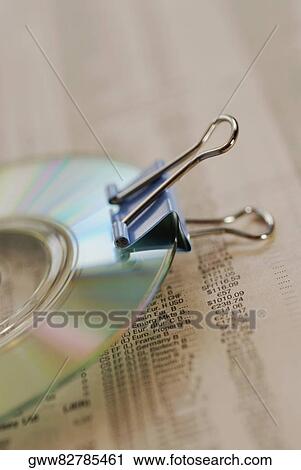 Close-up of a CD with a paper clip on a financial page View Large Photo Image Stock Image - Close-up of a CD with a paper clip on a financial page. Fotosearch
