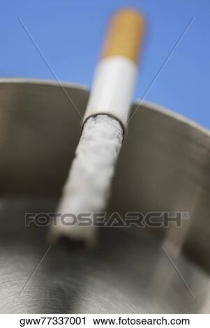Stock Image - Close-up of a cigarette in an ashtray. Fotosearch