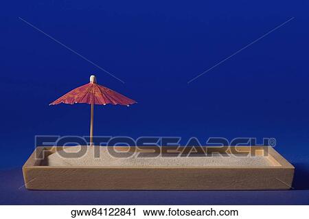 Close-up of a drink umbrella on a sandbox View Large Photo Image Stock Image - Close-up of a drink umbrella on a sandbox. Fotosearch