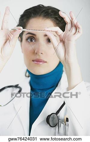 Close-up of a female doctor reading a thermometer View Large Photo Image Stock Image - Close-up of a female doctor reading a thermometer. Fotosearch