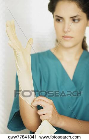 Close-up of a female doctor wearing a surgical glove View Large Photo Image Stock Image - Close-up of a female doctor wearing a surgical glove. Fotosearch