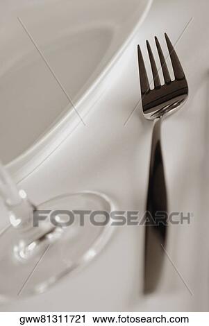 Close-up of a fork and a stem glass with a plate View Large Photo Image Stock Image - Close-up of a fork and a stem glass with a plate. Fotosearch