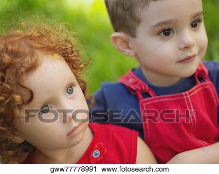 Stock Image - Close-up of a girl and her brother. Fotosearch