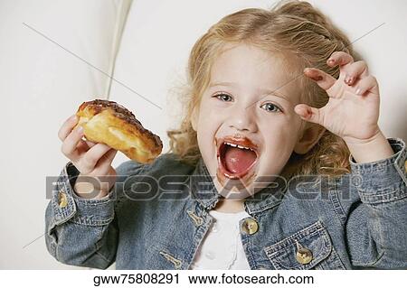 Stock Image - Close-up of a girl making a face. Fotosearch