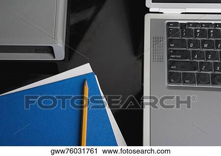 Close-up of a laptop with pencil on a notebook View Large Photo Image Stock Image - Close-up of a laptop with pencil on a notebook. Fotosearch