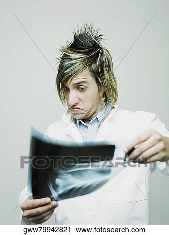 Close-up of a male doctor examining an X-Ray View Large Photo Image Stock Image - Close-up of a male doctor examining an X-Ray. Fotosearch