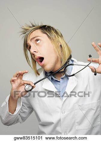 Close-up of a male doctor strangling himself with a stethoscope View Large Photo Image Stock Image - Close-up of a male doctor strangling himself with a stethoscope. Fotosearch