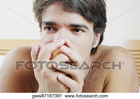 Close-up of a mature man eating an apple View Large Photo Image Stock Image - Close-up of a mature man eating an apple. Fotosearch