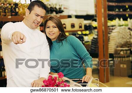 Close-up of a mid adult man and a young woman in a supermarket View Large Photo Image Stock Image - Close-up of a mid adult man and a young woman in a supermarket. Fotosearch