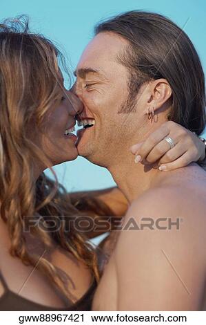 Close-up of a mid adult man and a young woman kissing each other View Large Photo Image Stock Image - Close-up of a mid adult man and a young woman kissing each other. Fotosearch