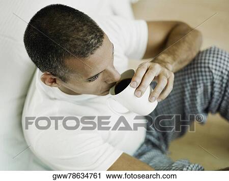 Close-up of a mid adult man drinking a cup of black tea View Large Photo Image Stock Image - Close-up of a mid adult man drinking a cup of black tea. Fotosearch