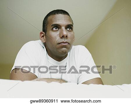 Close-up of a mid adult man lying on the bed View Large Photo Image Stock Image - Close-up of a mid adult man lying on the bed. Fotosearch