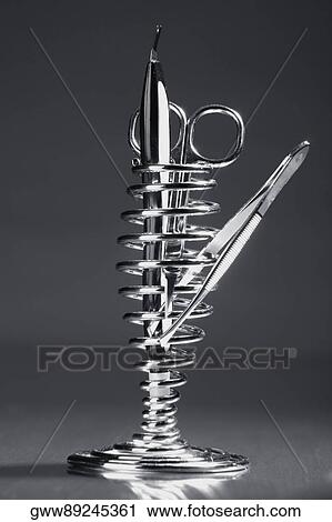 Close-up of a pair of scissors with a pair of tweezers View Large Photo Image Stock Image - Close-up of a pair of scissors with a pair of tweezers. Fotosearch