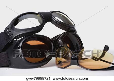 Stock Image - Close-up of a pair of sunglasses with two swimming goggles. Fotosearch