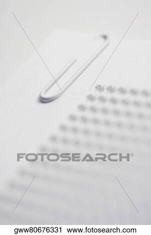 Close-up of a paper clip on a sheet of paper View Large Photo Image Stock Image - Close-up of a paper clip on a sheet of paper. Fotosearch