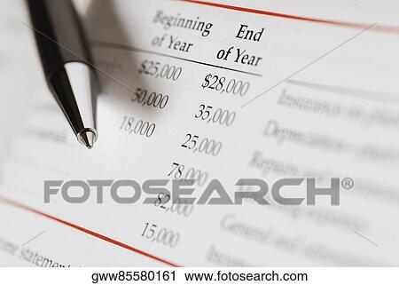 Close-up of a pen on a financial document View Large Photo Image Stock Image - Close-up of a pen on a financial document. Fotosearch