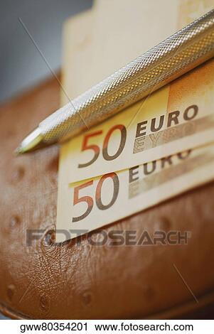 Close-up of a pen on fifty Euro banknotes View Large Photo Image Stock Image - Close-up of a pen on fifty Euro banknotes. Fotosearch