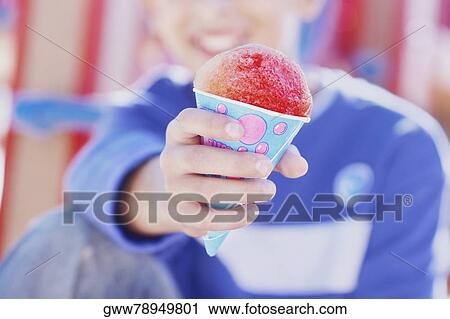 Close-up of a person showing an ice-cream cone View Large Photo Image Stock Image - Close-up of a person showing an ice-cream cone. Fotosearch