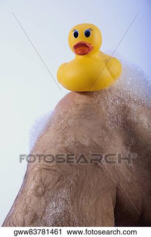 Close-up of a rubber duck on a man's knee View Large Photo Image Stock Image - Close-up of a rubber duck on a man's knee. Fotosearch