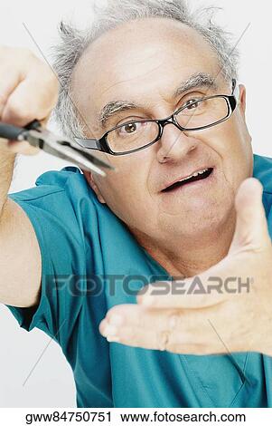 Close-up of a senior man holding a pair of pliers and making a face View Large Photo Image Stock Image - Close-up of a senior man holding a pair of pliers and making a face. Fotosearch