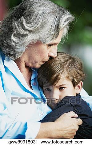 Close-up of a senior woman kissing her grandson View Large Photo Image Stock Image - Close-up of a senior woman kissing her grandson. Fotosearch