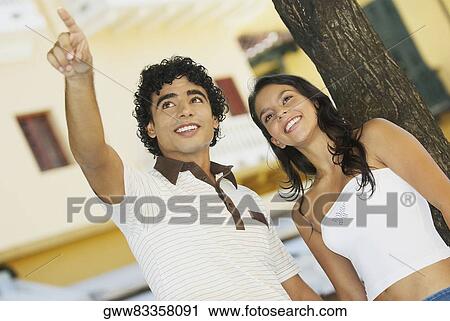 Close-up of a teenage boy pointing to a young woman View Large Photo Image Stock Image - Close-up of a teenage boy pointing to a young woman. Fotosearch