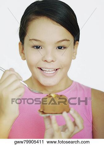 Close-up of a teenage girl holding a spoon and cake View Large Photo Image Stock Image - Close-up of a teenage girl holding a spoon and cake. Fotosearch