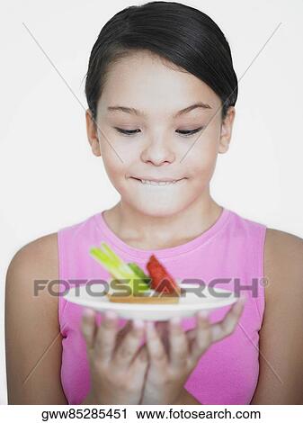 Close-up of a teenage girl looking at a pie in a plate View Large Photo Image Stock Image - Close-up of a teenage girl looking at a pie in a plate. Fotosearch