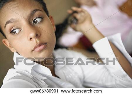 Stock Image - Close-up of a teenage girl thinking. Fotosearch