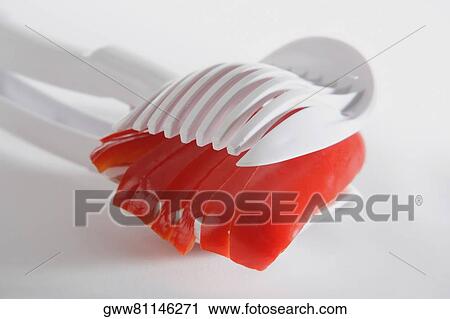 Close-up of a tomato in a pair of tongs View Large Photo Image Stock Image - Close-up of a tomato in a pair of tongs. Fotosearch