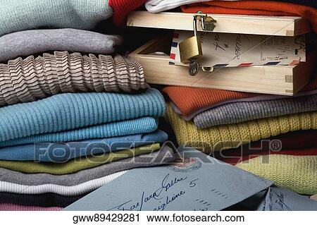 Close-up of a wooden box with folded sweaters View Large Photo Image Stock Image - Close-up of a wooden box with folded sweaters. Fotosearch