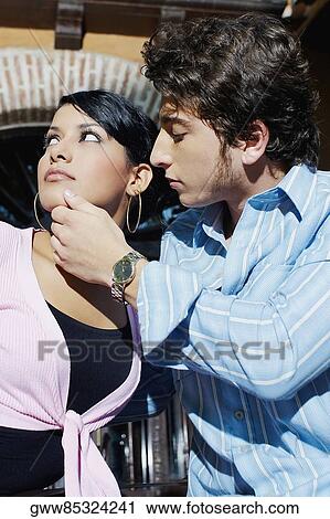 Close-up of a young couple sitting in front of a building, Cartagena, Colombia View Large Photo Image Stock Image - Close-up of a young couple sitting in front of a building, Cartagena, Colombia. Fotosearch