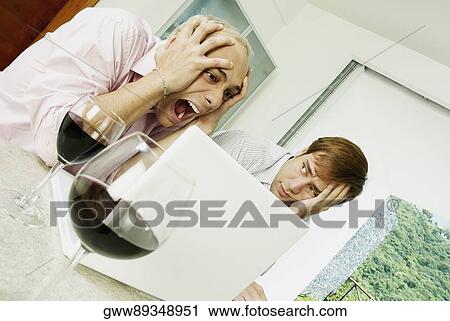 Close-up of a young man sitting with a shocked young man View Large Photo Image Stock Image - Close-up of a young man sitting with a shocked young man. Fotosearch