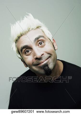 Stock Image - Close-up of a young man smirking. Fotosearch
