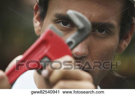 Close-up of a young man using an adjustable wrench View Large Photo Image Stock Image - Close-up of a young man using an adjustable wrench. Fotosearch