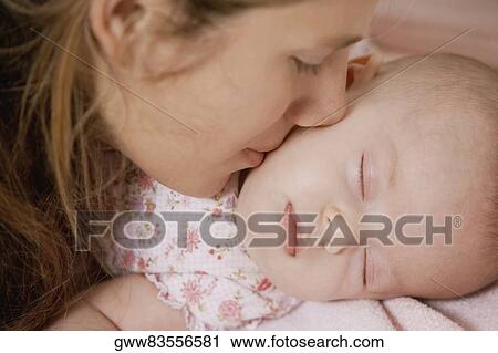 Close-up of a young woman kissing her daughter View Large Photo Image Stock Image - Close-up of a young woman kissing her daughter. Fotosearch