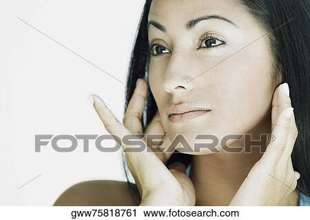Close-up of a young woman looking away View Large Photo Image Stock Image - Close-up of a young woman looking away. Fotosearch