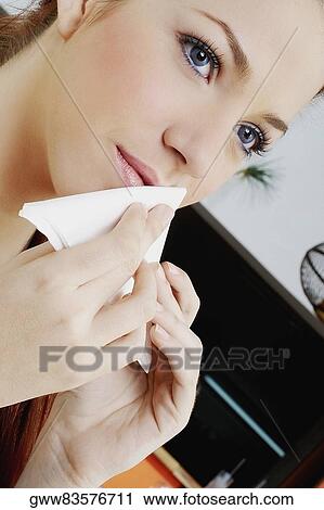 Close-up of a young woman rubbing her mouth with a tissue paper View Large Photo Image Stock Image - Close-up of a young woman rubbing her mouth with a tissue paper. Fotosearch