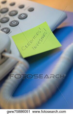 Stock Image - Close-up of an adhesive note on a telephone. Fotosearch