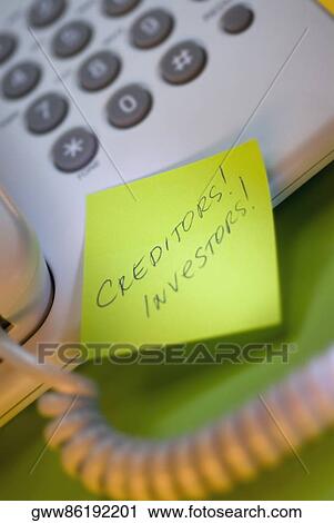 Stock Image - Close-up of an adhesive note on a telephone. Fotosearch