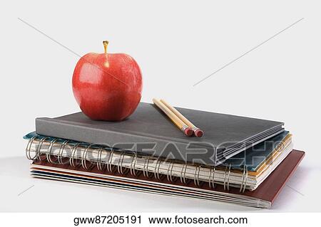 Close-up of an apple with two pencils on notebooks View Large Photo Image Stock Image - Close-up of an apple with two pencils on notebooks. Fotosearch