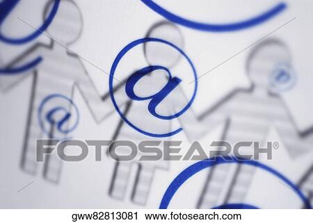 Stock Image - Close-up of an 'at' symbol on outline of paper chain dolls. Fotosearch