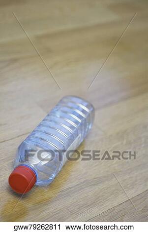 Close-up of an empty water bottle on a hardwood floor View Large Photo Image Stock Image - Close-up of an empty water bottle on a hardwood floor. Fotosearch