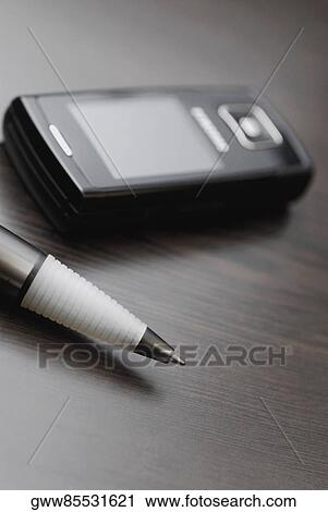 Close-up of ball point pen with a mobile phone View Large Photo Image Stock Image - Close-up of ball point pen with a mobile phone. Fotosearch