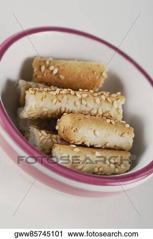 Stock Image - Close-up of breadsticks in a bowl. Fotosearch