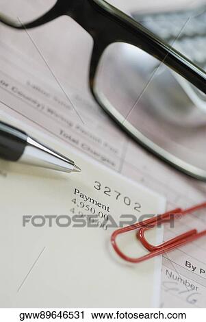 Close-up of eyeglasses with a pen and a document View Large Photo Image Stock Image - Close-up of eyeglasses with a pen and a document. Fotosearch