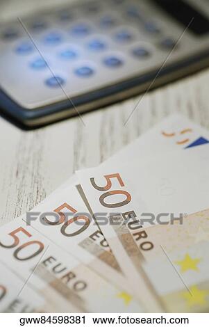 Close-up of fifty Euro banknotes and a calculator View Large Photo Image Stock Image - Close-up of fifty Euro banknotes and a calculator. Fotosearch