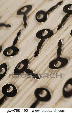 Close-up of keys on a wooden surface View Large Photo Image Stock Image - Close-up of keys on a wooden surface. Fotosearch