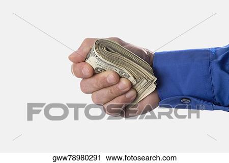 Close-up of man's hand holding a bundle of dollar bills View Large Photo Image Stock Image - Close-up of man's hand holding a bundle of dollar bills. Fotosearch