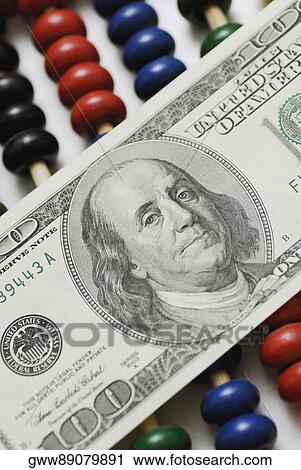Close-up of one hundred dollar bill on an abacus View Large Photo Image Stock Image - Close-up of one hundred dollar bill on an abacus. Fotosearch